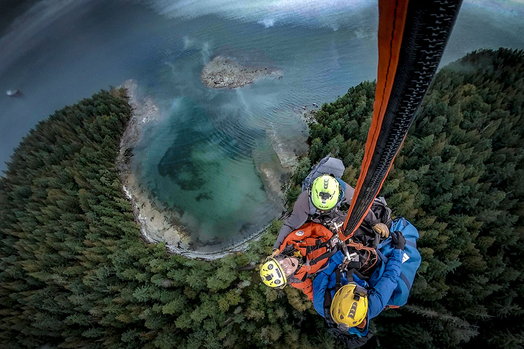 backcountry paddlers are pulled up to a helicopter after a mistake leads to rescue