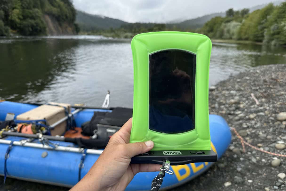 Holding phone up with raft and river gorge in the background.