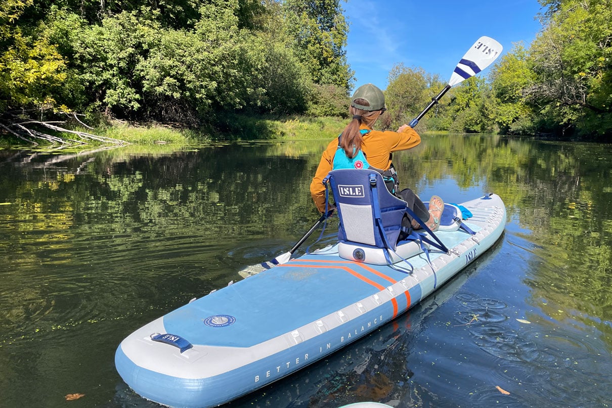 preson paddles the ISLE Explorer Pro hybrid SUP-kayak