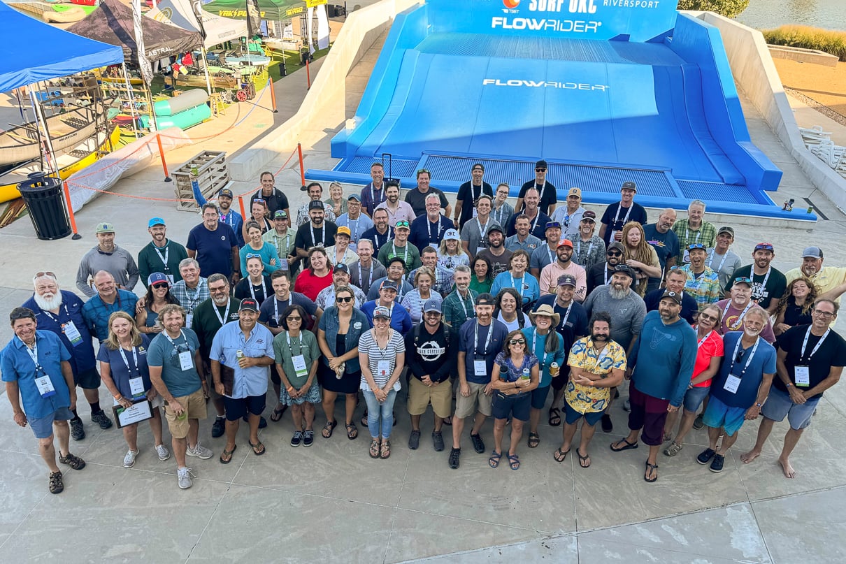 At PTC Colab 2024, paddlesports industry leaders gather for a photo.
