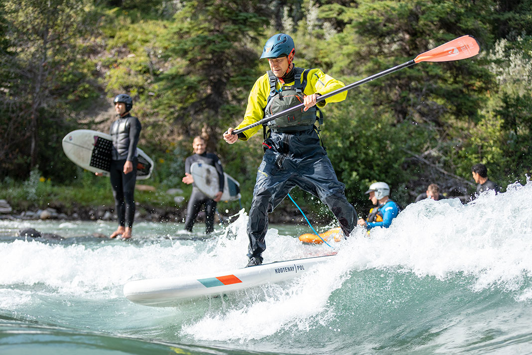 man rides surf paddleboard anywhere on the Kananaskis River