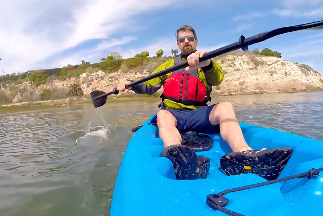 man paddling a kayak