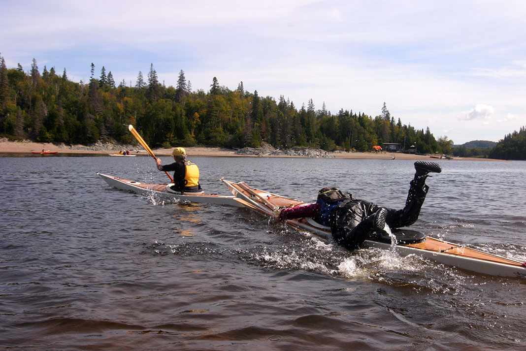 one kayaker uses his skills to tow another in an unusual kayak relay race